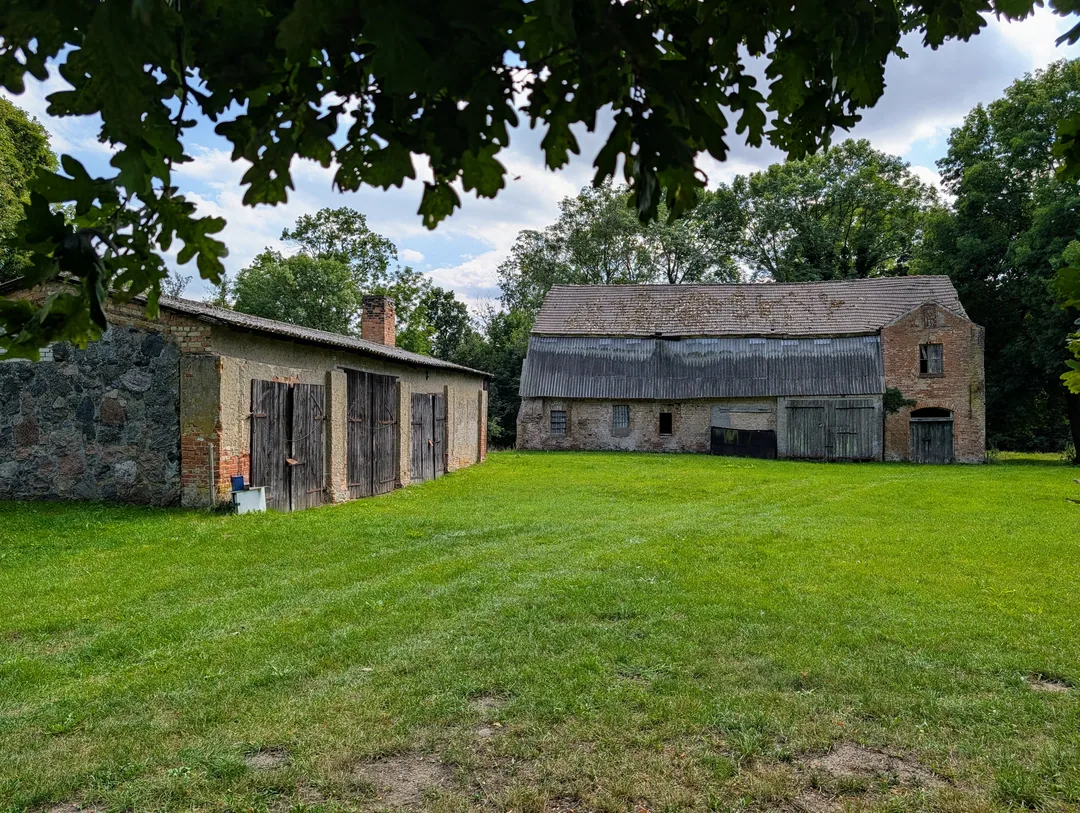 Remise mit Holztoren und große Feldsteinscheune am Wirtschaftshof in Putzar